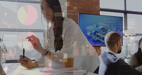 Woman leading analytics review leaning over documents in modern sunlit office with charts