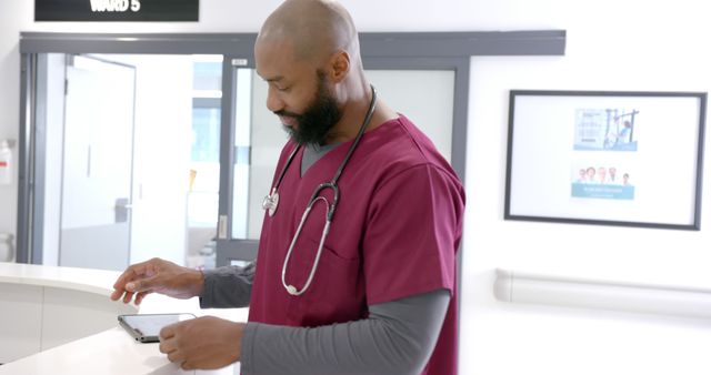 Confident Male Nurse Using Digital Tablet at Hospital Reception - Download Free Stock Images Pikwizard.com