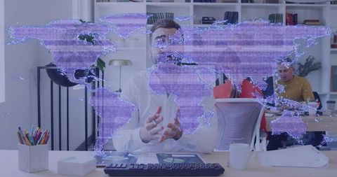 Businessman presenting digital world map overlay during team meeting in modern office