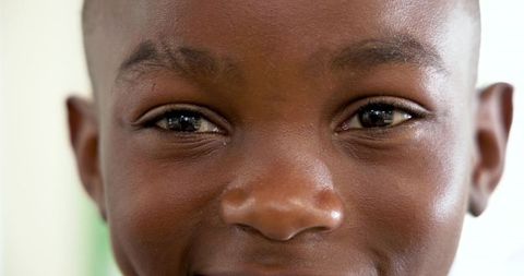 Close-Up Portrait of Smiling African American Boy with Vibrant Expression