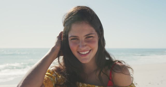 Portrait of caucasian woman standing and laughing on beach. Summer, free time, chill, vacation, happy time.