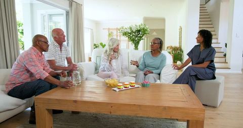Senior Friends Enjoying Social Gathering in Cozy Living Room