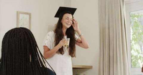 Cheerful graduate celebrating achievement at party