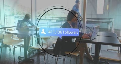 Urban Professional Typing on Laptop in Modern Café Setting