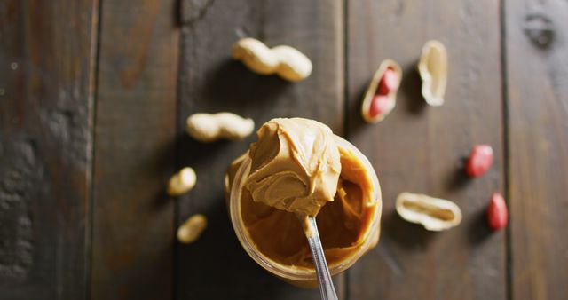 Close-up of Creamy Peanut Butter with Peanuts on Rustic Wooden Background - Download Free Stock Images Pikwizard.com