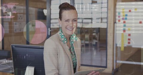 Businesswoman Engaging with Data Visualizations on Tablet in Office