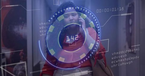 Professional woman walking in office corridor speaking on phone with futuristic HUD overlay