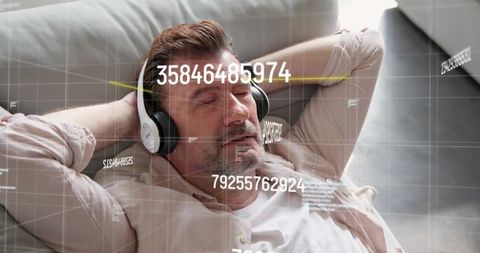 Reclining man wearing headphones on sofa with ar data overlays for relaxation