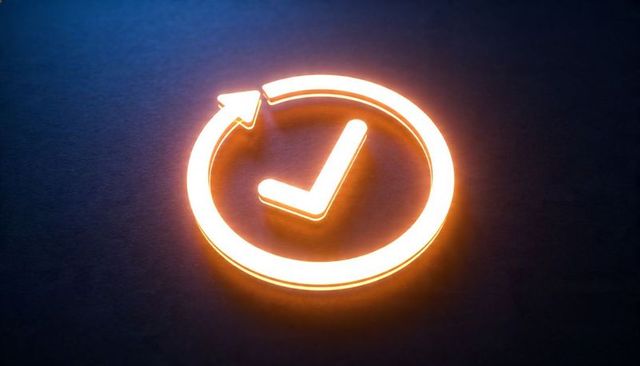 Glowing amber neon check mark with circular arrow icon on dark textured background