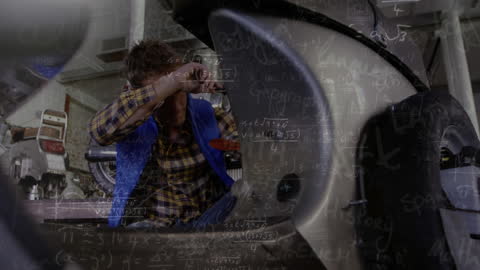 Mechanic Analyzing with Mathematical Equations in Workshop