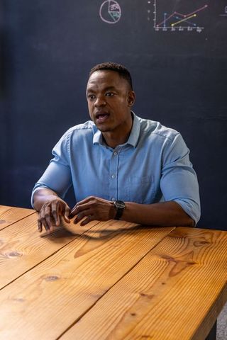 Professional discussion with chalkboard charts