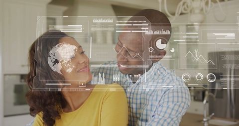 Smiling Couple with Financial Data Hologram in Kitchen