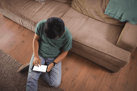 man engaging with tablet device on floor, home setting - Download Free Stock Videos Pikwizard.com