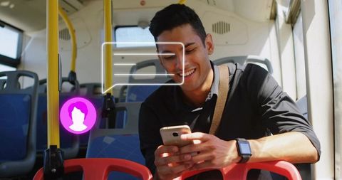 Young Man Messaging on Bus with Holographic Chat Icon Demonstrating Mobile Connectivity