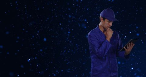 Engineer using tablet with glowing blue digital background