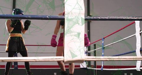 Female Boxers Sparring in Gym Ring Wearing Headgear and Pink Gloves Showing Focus