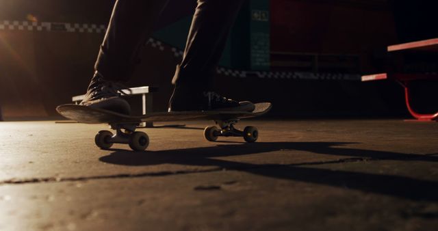 Person Practicing Skateboarding Indoors at Facility with Warm Lighting - Download Free Stock Images Pikwizard.com