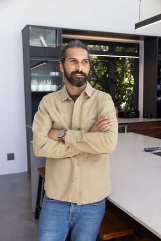 Man Relaxing in Modern Minimalist Kitchen Interior
