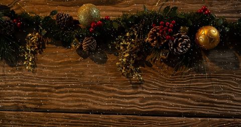Festive Christmas Garland with Falling Snow on Rustic Wooden Background - Download Free Stock Images Pikwizard.com