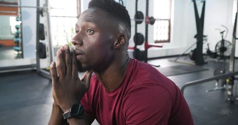 Thoughtful Athlete in Gym Incorporating Mindfulness During Workout