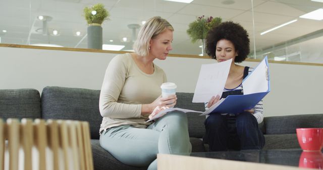 Two women collaborating on project in modern office lounge - Download Free Stock Images Pikwizard.com