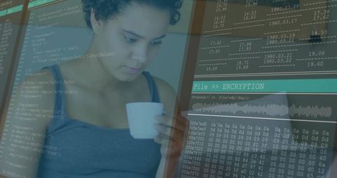 Software developer debugging encryption while grasping coffee mug