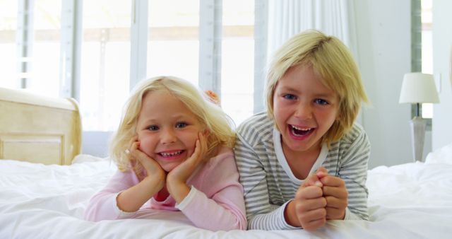 Happy Siblings Playing on Bed and Having Fun - Download Free Stock Images Pikwizard.com