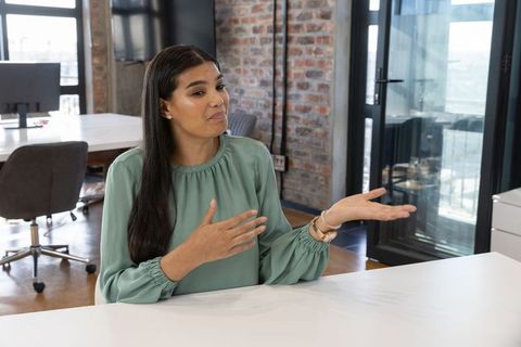 Confident Woman Communicating in Modern Office