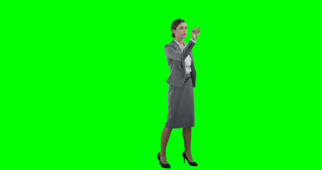 Businesswoman Writing on Invisible Screen, Isolated Green Background - Download Free Stock Images Pikwizard.com