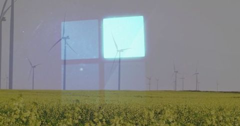 Wind turbines overlooking farmland with abstract blue light