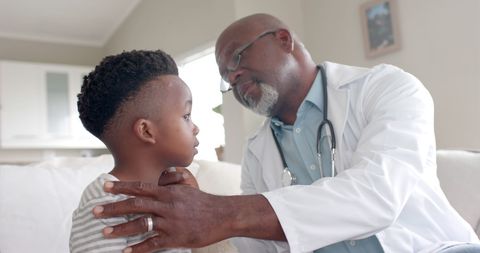 Doctor Conducting Home Ear Checkup for Young Boy