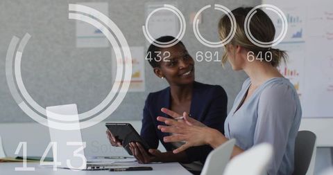 Collaborating with tablet and augmented analytics overlay in modern office meeting