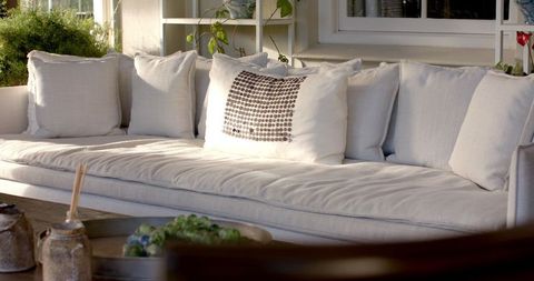 Elegant white sofa on inviting sunlit patio