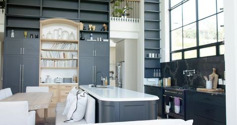 Loft Kitchen Showcasing Central Island with White Quartz Countertop and Minimal Mezzanine