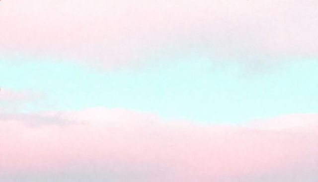 Pastel sunrise horizon with soft pink and mint gradient clouds for calm backgrounds