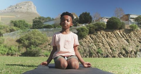 Young Boy Practicing Mindfulness in Scenic Outdoor Setting