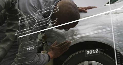 Automotive Technician Inspecting Sanded Car Fender with Digital Overlay Showing Dates