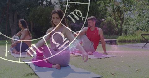 Yoga Class with Zodiac Projection on Green Lawn