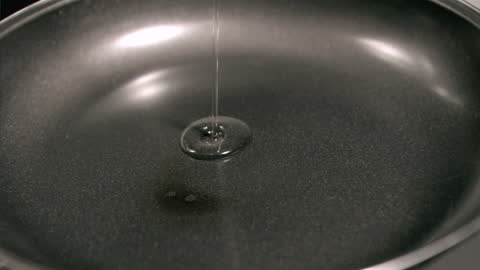Oil Pouring in Slow Motion into Empty Frying Pan