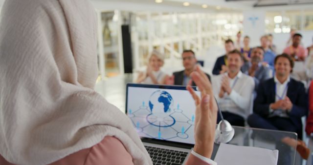 Businesswoman in Hijab Giving Presentation to Engaged Audience - Download Free Stock Images Pikwizard.com