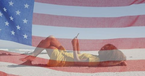 Patriotic relaxation: woman on beach with american flag overlay