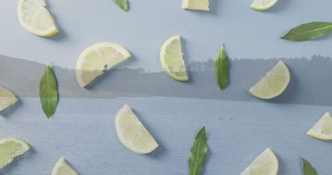 Floating citrus and bay leaves over misty lakeside serenity