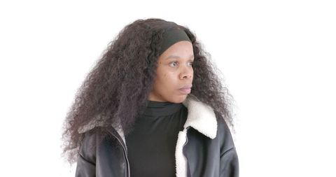 Pensive Woman Looking Away in Black Jacket on White Background
