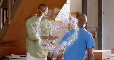 Technicians examining glowing portal ring in workshop demonstrating futuristic collaboration