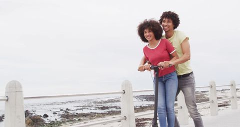 Joyful Couple Enjoying Scooter Ride by the Beach - Download Free Stock Images Pikwizard.com