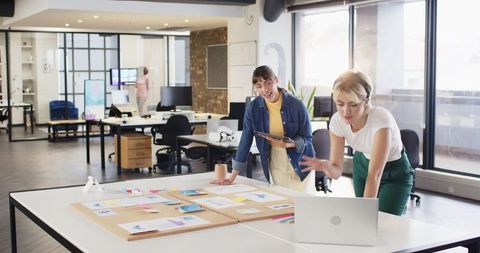 Diverse Female Designers Collaborating in Modern Office Workspace