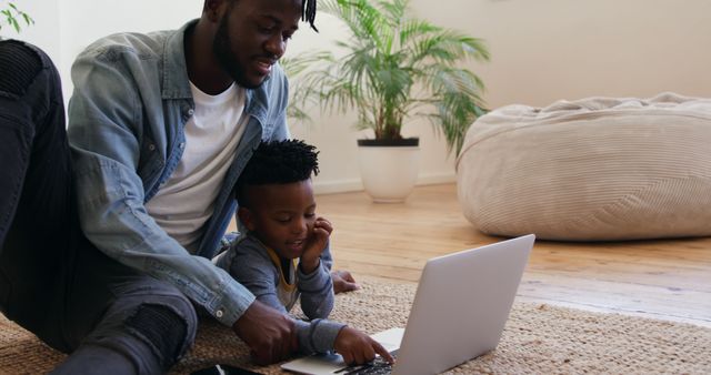 Father and Son Using Laptop Sitting on Floor in Cozy Living Room - Download Free Stock Images Pikwizard.com