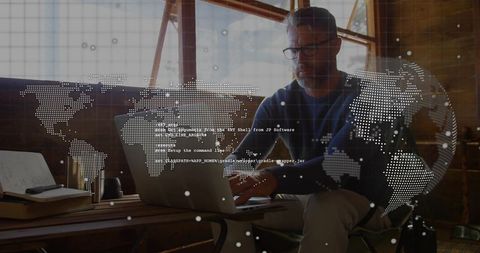 Remote software engineer coding on laptop in sunlit loft with global data overlay