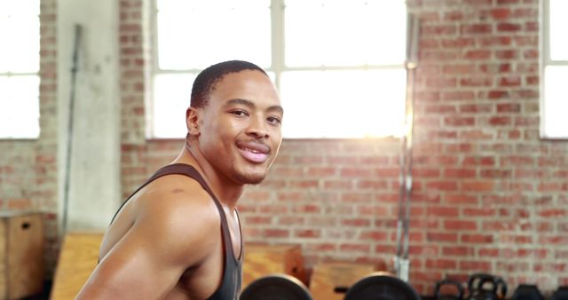 Athletic Man Smiling in Gym with Sunlight - Download Free Stock Images Pikwizard.com