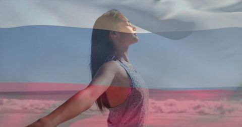Woman embracing ocean breeze with tricolor light overlay at sunlit beach